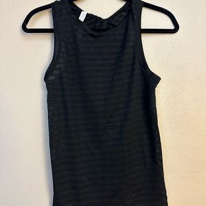 Lululemon tank top. Black sheer design. Ties in the back. Size 2. Never worn